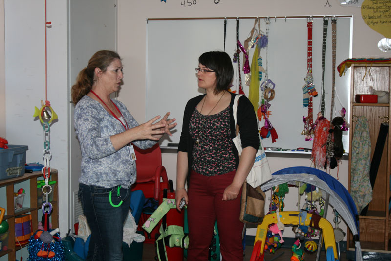 Fjolla (right) receives some instruction on working with disabled children from Sharon Abdella at Doris Klaussen Development Center.