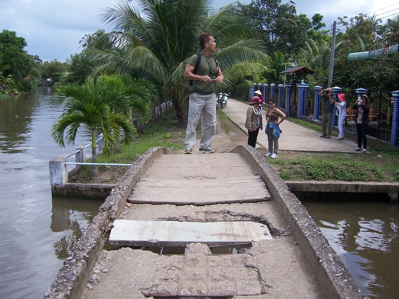 Bach Pham from DCHA stands on the old bridge that was to be replaced.