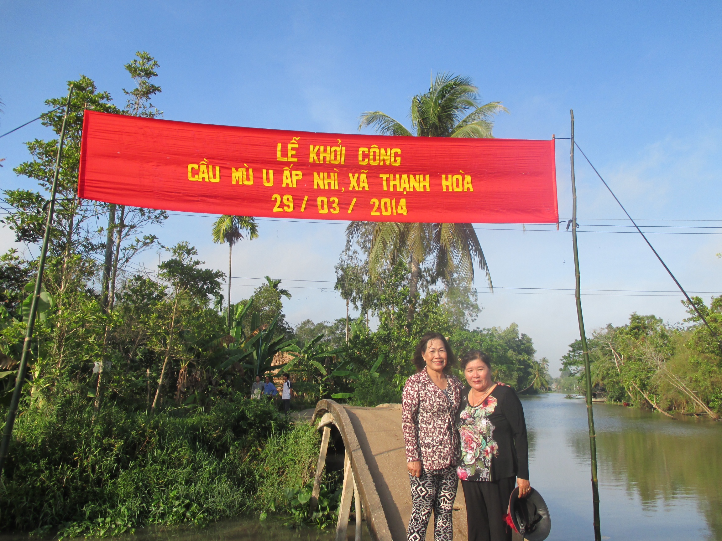 Preparation for dedication for new bridge project. The two ladies are Red Cross representatives. 